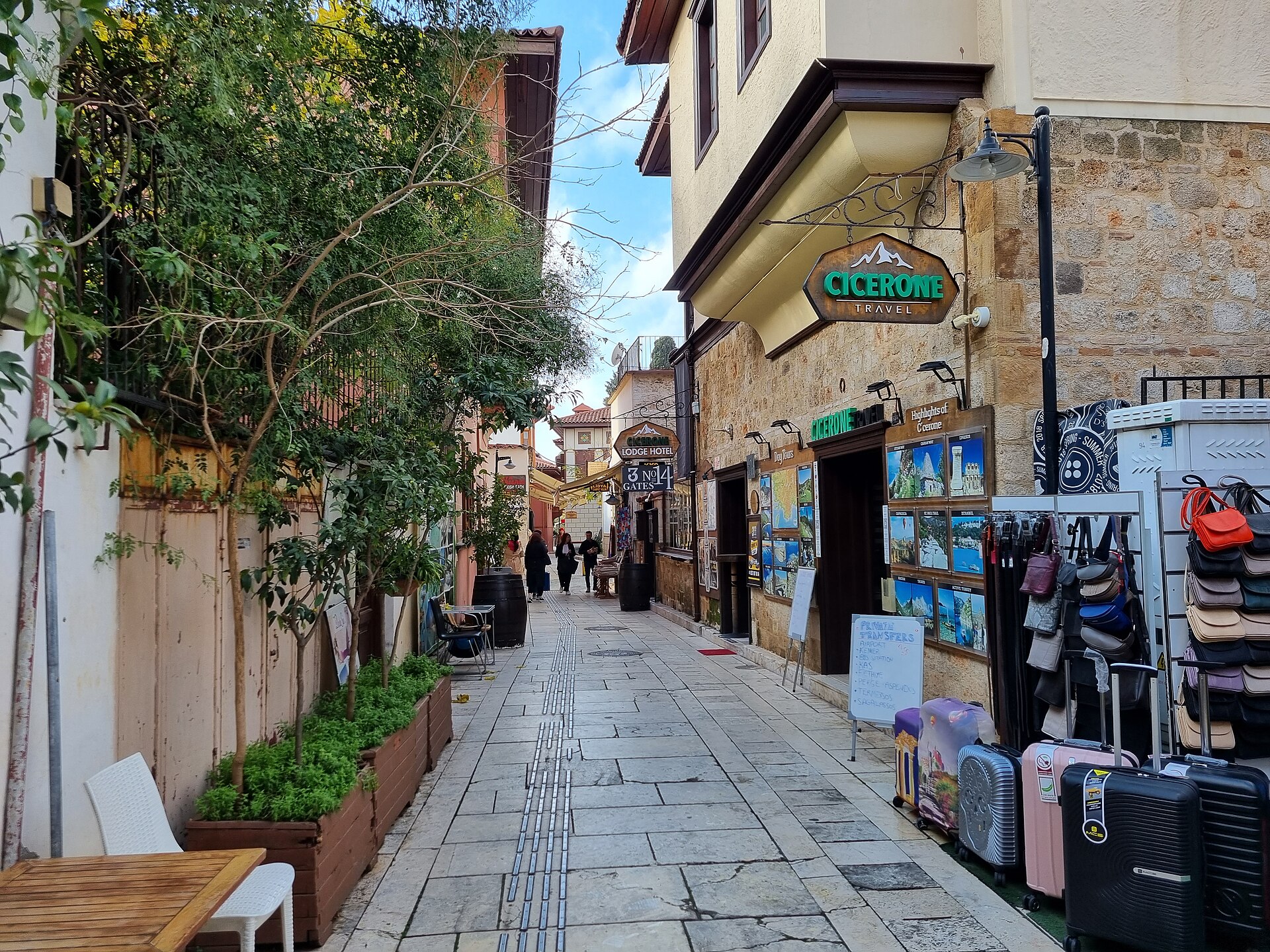 Another Kaleiçi lane in Antalya's old town: restored Ottoman houses, wooden shutters, a cobbled street curving out of sight.
